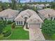 Expansive aerial view of a luxury home with lush landscaping and a private pool at 501 Sotheby Way, Debary, FL 32713