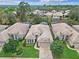 An aerial view shows a well-maintained single-story home in a landscaped community with mature trees at 501 Sotheby Way, Debary, FL 32713