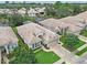 An aerial shot shows a well-maintained single-story home with mature trees in a landscaped community at 501 Sotheby Way, Debary, FL 32713