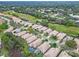 An aerial view of a residential neighborhood adjacent to a golf course; lush greenery and well-maintained homes at 501 Sotheby Way, Debary, FL 32713