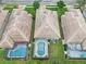 An aerial shot shows a residential neighborhood featuring mature trees and fenced-in pools and backyards at 501 Sotheby Way, Debary, FL 32713