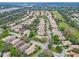 Aerial view of a residential neighborhood featuring well-maintained homes, trees, and a golf course at 501 Sotheby Way, Debary, FL 32713