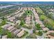 Aerial view of a residential neighborhood featuring well-maintained homes, trees, and a golf course at 501 Sotheby Way, Debary, FL 32713