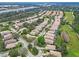 Aerial view of a residential neighborhood featuring well-maintained homes, trees, and a golf course at 501 Sotheby Way, Debary, FL 32713