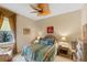 Well-lit guest bedroom features a ceiling fan, cozy bedding, and ample natural light at 501 Sotheby Way, Debary, FL 32713