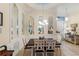 Elegant dining room with decorative mirrors, a chandelier, and a dark wood table at 501 Sotheby Way, Debary, FL 32713