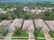 Aerial view of single-story home with tile roof, manicured lawn, and lush landscaping at 501 Sotheby Way, Debary, FL 32713