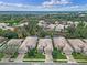 Aerial view of single-story homes with tile roofs, manicured lawns, and lush landscaping at 501 Sotheby Way, Debary, FL 32713