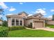 A single-story home is beautifully landscaped with a well manicured lawn and a two-car garage at 501 Sotheby Way, Debary, FL 32713