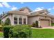 A single-story home is beautifully landscaped with a well manicured lawn and a two-car garage at 501 Sotheby Way, Debary, FL 32713