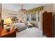 Serene bedroom featuring a ceiling fan, bay windows and comfortable furnishings, ideal for relaxation at 501 Sotheby Way, Debary, FL 32713