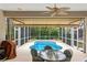 Screened-in lanai with a kidney-shaped pool and cozy outdoor seating area at 501 Sotheby Way, Debary, FL 32713