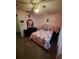 Cozy bedroom with ceiling fan, laminate flooring, and soft pink walls at 550 Oak Branch Cir, Kissimmee, FL 34758