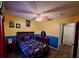 Cozy bedroom featuring hardwood floors, two toned walls, and a ceiling fan at 550 Oak Branch Cir, Kissimmee, FL 34758