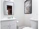 Bathroom featuring modern sink and toilet fixtures with an adjacent decorative print for comfort at 607 Powers Ave, Port Orange, FL 32127