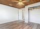 Bedroom features wood ceiling, wood-look floors, closet, and entry door at 607 Powers Ave, Port Orange, FL 32127