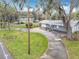 Charming home surrounded by lush greenery, featuring a long driveway and a nautical themed boundary at 607 Powers Ave, Port Orange, FL 32127