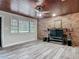 Inviting living room featuring wood ceiling, brick wall, and neutral-toned flooring at 607 Powers Ave, Port Orange, FL 32127