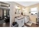 Bathroom with granite countertops, double sinks, and an open doorway to the bedroom at 618 Minnesota Ave, St Cloud, FL 34769