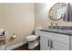 Cozy half-bath with an ornate mirror, granite countertop and modern fixtures at 618 Minnesota Ave, St Cloud, FL 34769