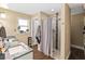 Bright bathroom with double sink vanity, granite countertop, and tiled shower at 618 Minnesota Ave, St Cloud, FL 34769