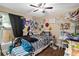 Neutral bedroom featuring wood floors, ceiling fan, and natural light at 618 Minnesota Ave, St Cloud, FL 34769