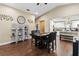 Bright dining area with wood floors, view to kitchen and stylish shelving unit with decorative items at 618 Minnesota Ave, St Cloud, FL 34769