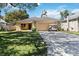 Inviting single-story home featuring a well-manicured lawn and a spacious driveway leading to an attached two-car garage at 618 Minnesota Ave, St Cloud, FL 34769