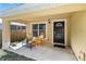 Charming front porch area with seating and a stylish black front door, perfect for relaxing outdoors at 618 Minnesota Ave, St Cloud, FL 34769