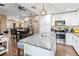 Open-concept kitchen with granite countertops and view of the dining and living room areas at 618 Minnesota Ave, St Cloud, FL 34769