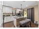 Modern kitchen with white cabinetry, granite countertops, stainless steel appliances, and natural light at 618 Minnesota Ave, St Cloud, FL 34769