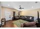 Inviting living room featuring a large sectional sofa, wood floors, and modern ceiling fan at 618 Minnesota Ave, St Cloud, FL 34769