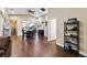 Open-concept living and dining area featuring dark wood floors and view into the kitchen at 618 Minnesota Ave, St Cloud, FL 34769