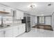 Modern kitchen with white cabinets, stainless steel appliances, and marble countertops at 630 N Nashua Ave, Fort Meade, FL 33841