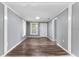 Cozy living room with new laminate flooring, fresh paint, and abundant natural light at 630 N Nashua Ave, Fort Meade, FL 33841