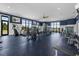 Well-equipped gym with modern fitness machines, large windows, and blue accent walls at 7071 Painted Bunting Way, St Cloud, FL 34773