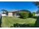 View of a beautiful backyard with a screened-in pool and lush green landscaping at 713 Duff Dr, Winter Garden, FL 34787