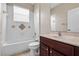 Well-lit bathroom features a white tub, a toilet, and a vanity with a mirror, creating a functional space at 713 Duff Dr, Winter Garden, FL 34787