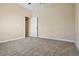 Neutral bedroom featuring soft carpet, a doorway, and a closet, creating a comfortable and inviting space at 713 Duff Dr, Winter Garden, FL 34787