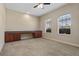 Bedroom with neutral walls and carpet and a built-in desk/cabinet feature under two windows at 713 Duff Dr, Winter Garden, FL 34787