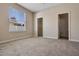 Carpeted bedroom features a window, closet, and doorway, offering a serene retreat at 713 Duff Dr, Winter Garden, FL 34787