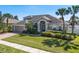 Charming two-story home featuring a well-manicured lawn, brick driveway, and mature landscaping at 713 Duff Dr, Winter Garden, FL 34787