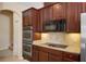 Well-equipped kitchen with stainless steel double ovens and cooktop at 713 Duff Dr, Winter Garden, FL 34787