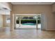 Living room view with tiled floor and glass sliding doors to a screened pool at 713 Duff Dr, Winter Garden, FL 34787