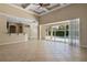 Bright living room with sliding glass doors that open to the pool area and kitchen at 713 Duff Dr, Winter Garden, FL 34787