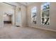 Inviting living room with plush carpeting, tray ceiling, and large arched windows at 713 Duff Dr, Winter Garden, FL 34787