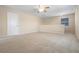 Large loft space featuring neutral carpet and paint, door, and natural light through the window at 713 Duff Dr, Winter Garden, FL 34787