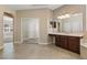 Main bathroom featuring dual sinks, large mirrors, and tile flooring at 713 Duff Dr, Winter Garden, FL 34787