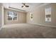 Spacious main bedroom with carpet, tray ceiling and windows providing plenty of natural light at 713 Duff Dr, Winter Garden, FL 34787