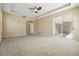 Carpeted main bedroom with tray ceilings and sliding doors leading to the patio at 713 Duff Dr, Winter Garden, FL 34787